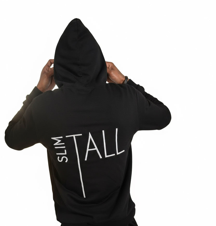 Person wearing a black hoodie with 'SLIM TALL' text on a white background