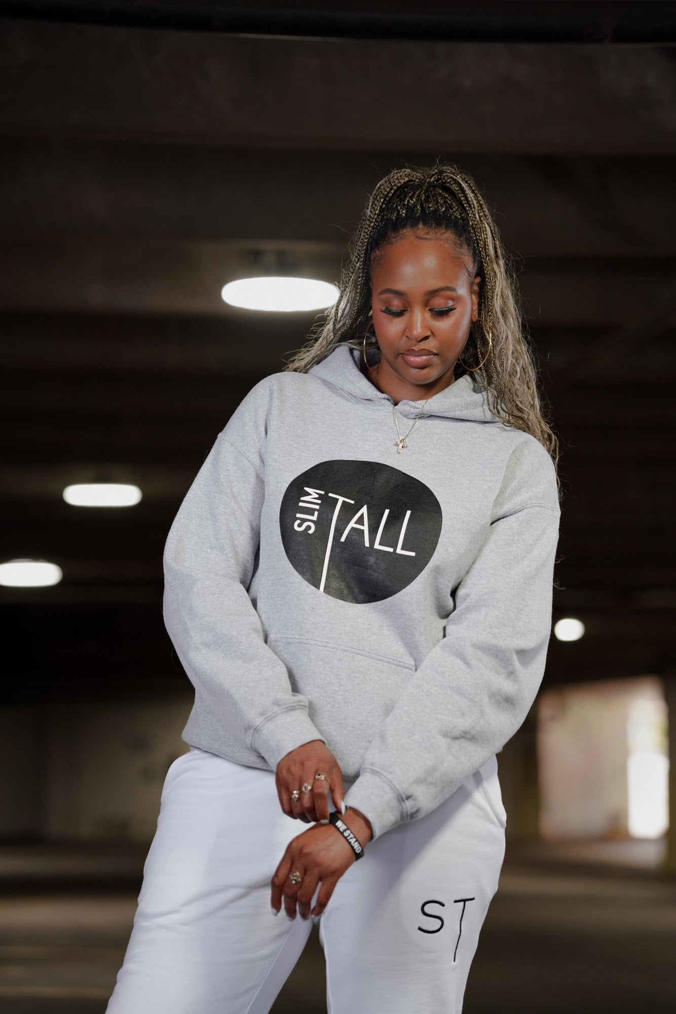 SlimTall Signature Hoodie in grey with the black circle logo, worn with the white tracksuit joggers