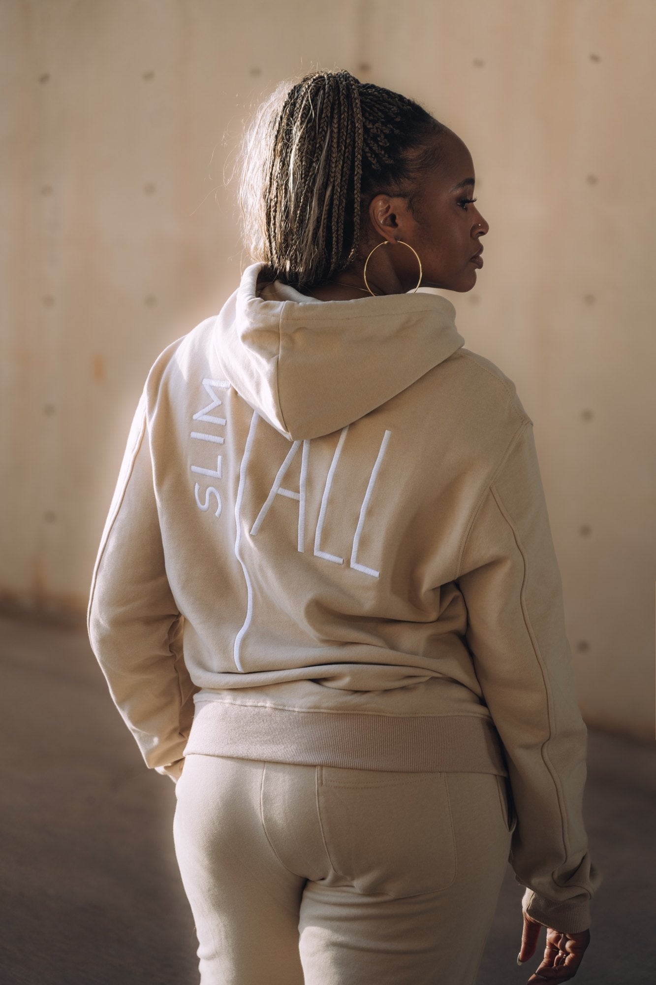 SlimTall tan tracksuit set, back with embroidered logo. Model is 5'11" wearing size L